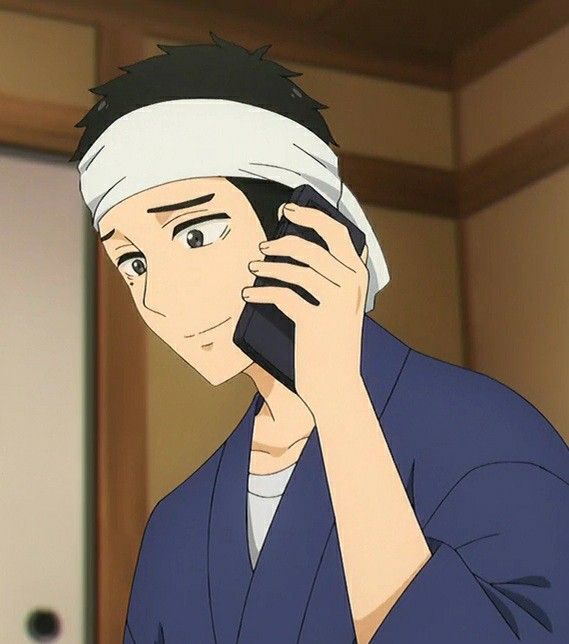 this is a closeup portrait of an anime male character in a traditional japanese kimono, speaking on his phone. he is smiling and looks pleased with the conversation. he has black hair and is wearing a headband. the background is out of focus, and a wooden door is visible.