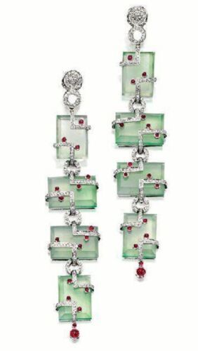 a pair of exquisite earrings featuring a cascade of jade and diamond elements. each earring has a chainlike structure with square jade stones and a delicate diamond trim.  the jade stones are a soft, light green, and each is adorned with a small ruby accent.  the earrings are attached with a small ruby at the top and dangle in a graceful fashion.