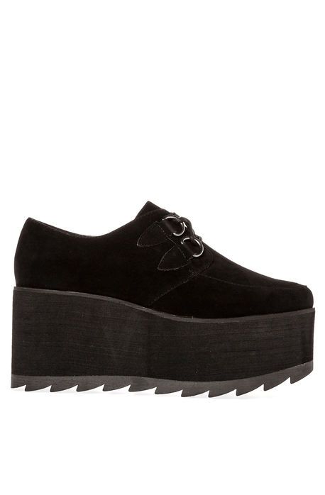 a black, suede platform shoe with a round toe and a chunky sole. the shoe has a strap with silver rings across the vamp.