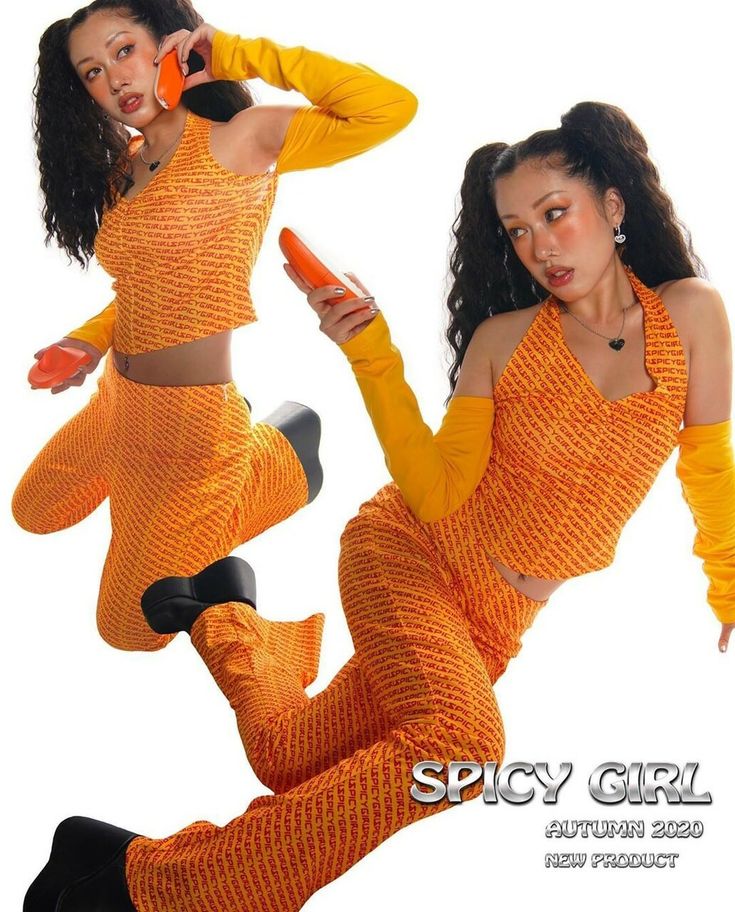 two women are wearing matching orange and yellow outfits. the woman on the left is posing with her back to the camera, while the woman on the right is looking at the camera. the woman on the right is holding a phone.