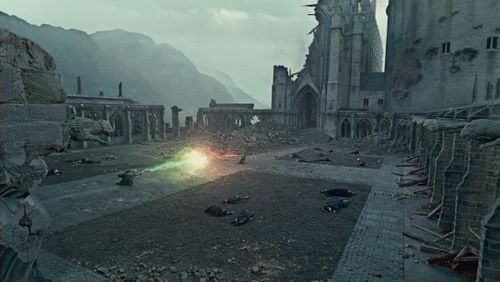 the image depicts a scene of utter devastation, likely a postbattle scenario. the setting is a ruined castle or large building complex, with gothic architecture in varying states of collapse.  rubble and debris are scattered across the ground. several bodies lie lifeless on the ground, suggesting a high death toll. a green magical light or spell emanates from the midground. in the background, mountains rise under a dreary sky. the overall mood is dark, gloomy and desolate, evocative of a final, decisive battle. the style strongly suggests a fantasy setting, possibly from a film like harry potter.