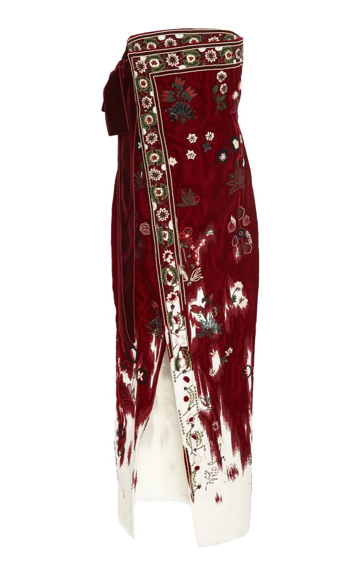 a maroon, strapless dress with floral embroidery. the dress features a slit and white trim.