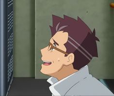 a side profile of an adult man with short brown hair, wearing glasses and a white shirt. he is inside and appears to be looking up at something with a content expression on his face.