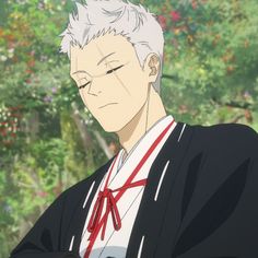 the image features an anime male character with white hair, a scar on his left eye, and a serious expression. he is wearing a black and white outfit with a red tie. he is looking down and appears to be in deep thought. the background is a blur of green foliage.