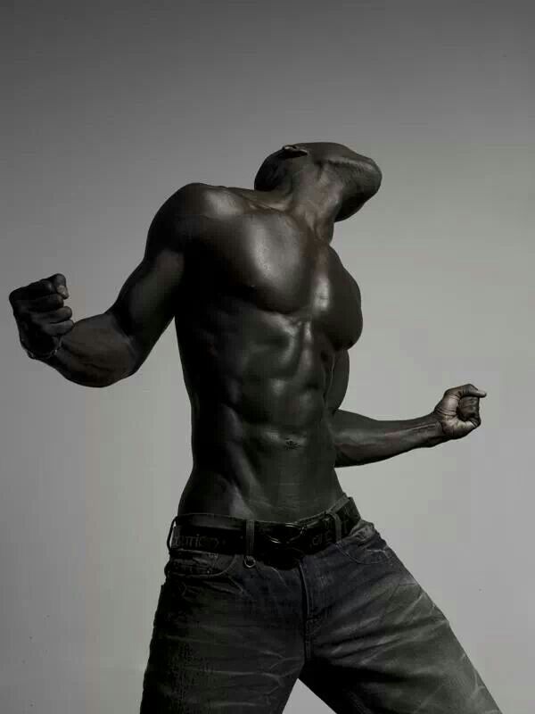 a muscular black man poses with his head tilted back and arms outstretched. he has a toned, sixpack abdomen and a powerful physique. he is lit by a soft light that creates a dramatic contrast between his dark skin and the white background. his expression is confident and assertive.