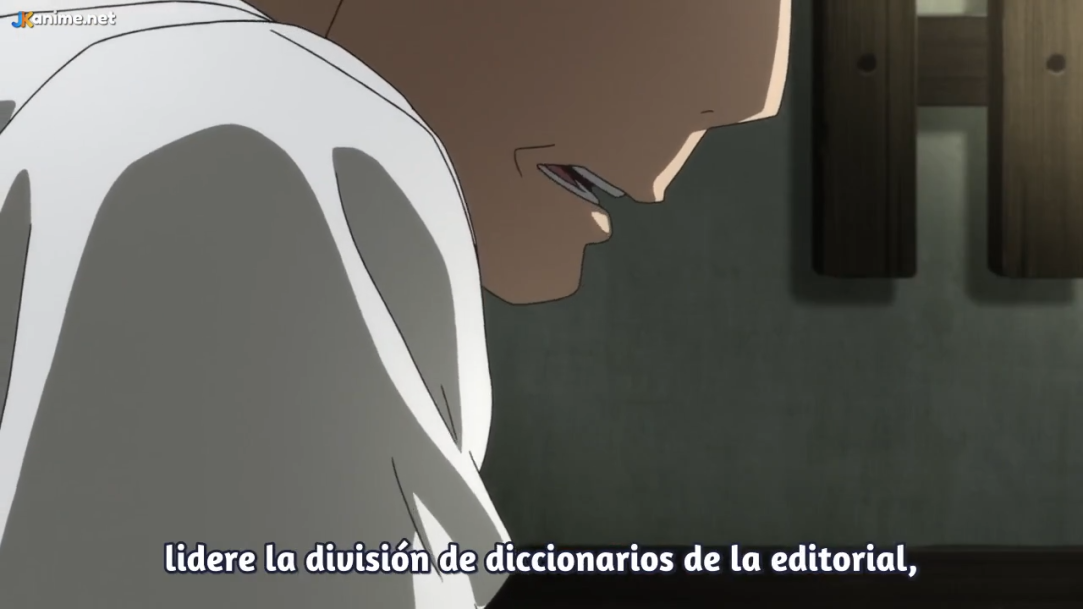 a closeup side profile of a man's face from an anime.  he appears to be midconversation and his expression suggests he is upset or stressed.  the scene is dimly lit and takes place indoors. spanish text is visible at the bottom of the image.