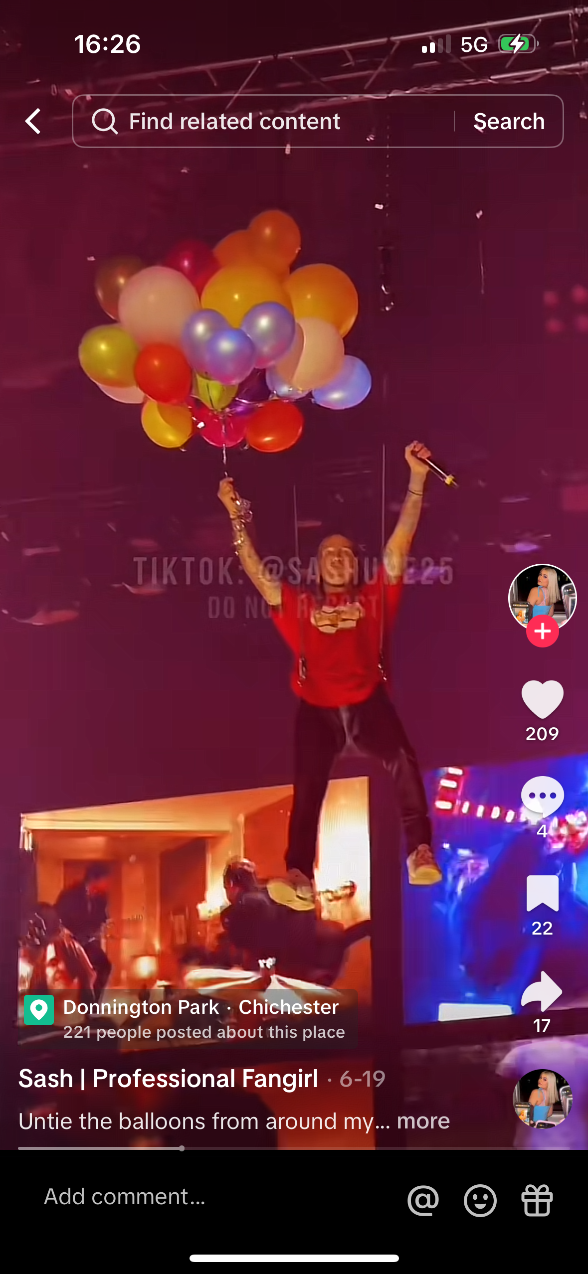 a woman in a red shirt is dancing and holding a bunch of multicolored balloons in her hands.  the video is from tiktok, and the description says, "untie the balloons from around my..."  the background is a blurry image of a building.  a small video in the top right of the screen shows a girl in a blue shirt smiling.  the video is about a fan girl who is excited to celebrate.