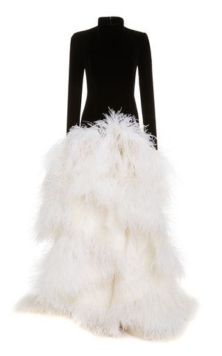 a black longsleeve turtleneck dress with a tiered skirt made of white feathers. the dress is photographed against a white background.