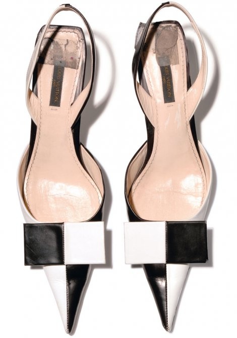 a pair of black and white louis vuitton slingback heels with pointed toes are displayed on a white background. the shoes have a checkerboard pattern detail at the front.
