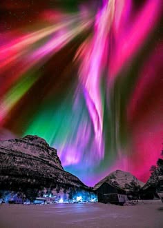 a breathtaking view of the aurora borealis, also known as the northern lights, dancing across the night sky over a snowcapped mountain range. the sky is ablaze with vibrant shades of green, pink, and purple, creating a magical and aweinspiring spectacle. the darkness of the night enhances the brilliance of the celestial display, highlighting the beauty and wonder of nature. the image captures the essence of a cold, wintery wilderness, inviting viewers to imagine themselves standing beneath this celestial show.