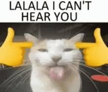 the image is a meme featuring a white cat with a playful expression, its tongue sticking out slightly. two yellow cartoon hands are depicted on either side of the cat's head, mimicking the action of covering the ears.  above the cat, the text "lalala i can't hear you" is displayed. the overall message is humorous, implying the cat is deliberately ignoring something or someone. the meme uses simple graphics and text to convey a common feeling of playful avoidance.