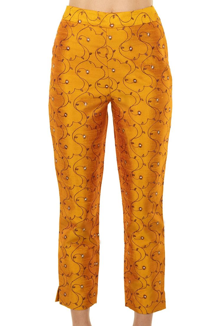 a pair of women's yellow cropped pants with a floral embroidered design. the pants are fitted and have a casual, comfortable style. they would be perfect for a party or a night out.