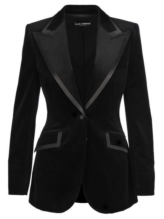 the image showcases a sophisticated black velvet blazer designed by dolce & gabbana. the blazer features a classic onebutton closure, a notch lapel with trim detail, and structured tailoring for a flattering fit. the velvet fabric and design make it suitable for evening wear and formal occasions. the blazer has pockets and a professional look.