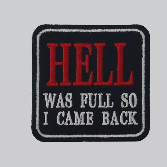 the image shows an embroidered patch. the patch is square with rounded corners, and has a black background and a white stitched border. the text "hell" is embroidered in red at the top of the patch, and below that, the text "was full so i came back" is embroidered in white.