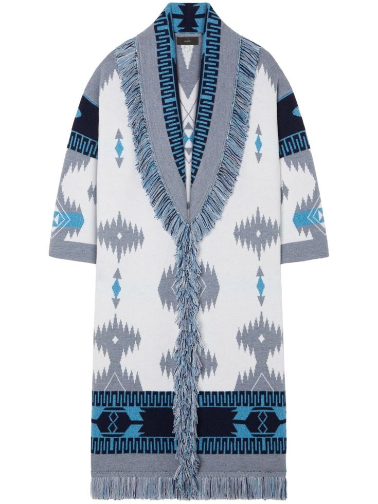 a white, grey and blue knitted cardigan with fringe detailing. the cardigan is long and has a geometric pattern. it appears to be a women's cardigan.