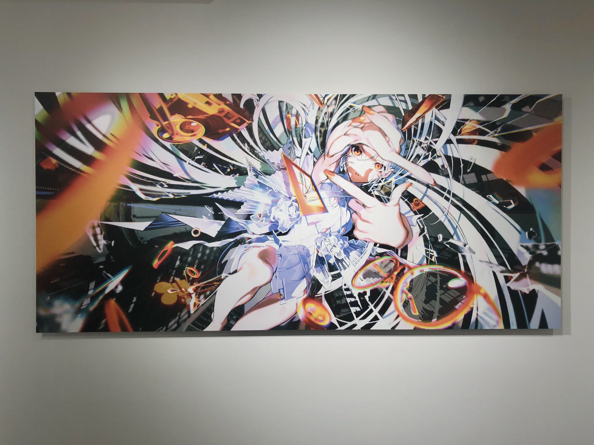 a large horizontal canvas print of anime art hangs on a white wall with spotlight shining from above. the anime art features a girl with long white hair, blue eyes, and wearing a white dress falling through what appears to be a digital space.  she has her hands up to her face with index and middle finger extended on both hands forming a "v" with each. the background is an abstract mix of black, white, and orange shapes. there is a pair of orange glasses in the bottom right corner. the art style is colorful and dynamic.