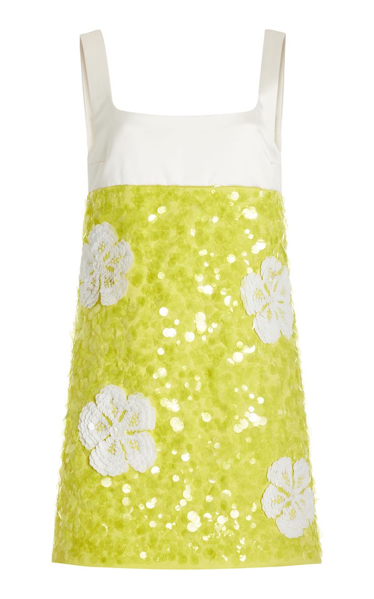 a yellow sequined dress with white floral details. the dress is sleeveless and has a scoop neck. it is made of a light fabric and is perfect for a summer party.