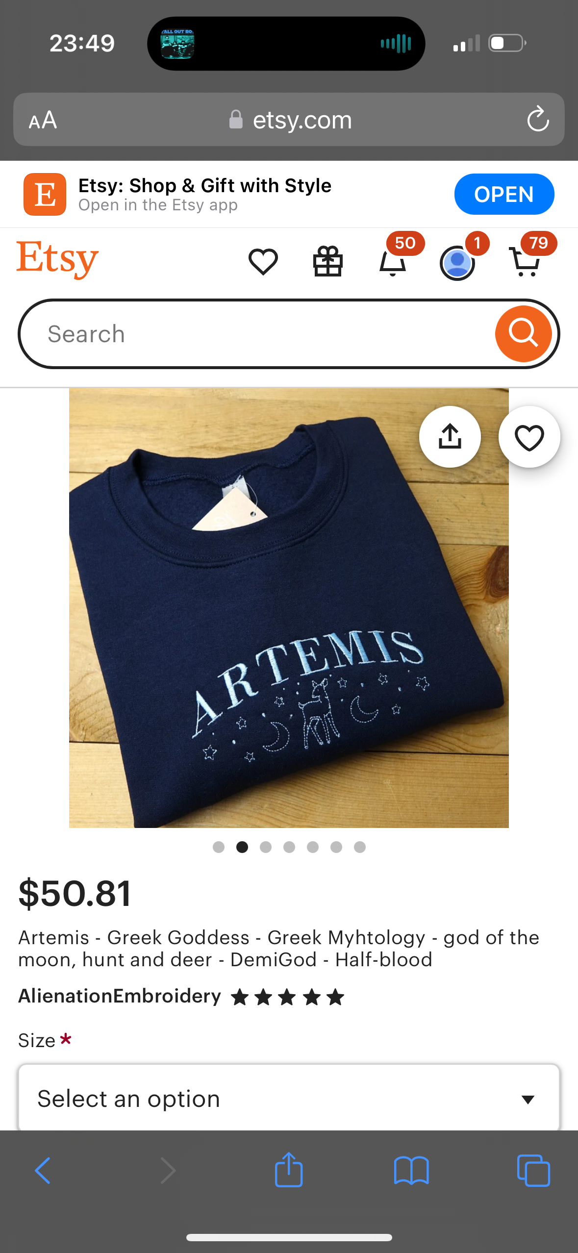 an etsy product listing for a blue sweatshirt with the words "artemis" and a design of a crescent moon, stars and a deer embroidered on it. the description says the sweatshirt is inspired by the greek goddess artemis and her role in greek mythology as the goddess of the moon, hunt, and wilderness. it also mentions that artemis is a demigod and halfblood.