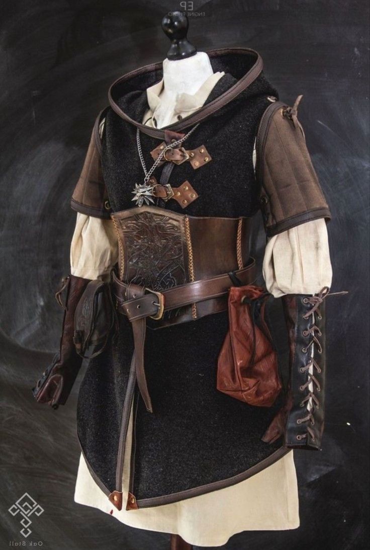 a black and brown medieval style costume with a leather belt and a bag hanging from it. the person wearing the costume has on brown leather gloves.  it looks like a woman's costume and perhaps a warrior or game of thrones type character.