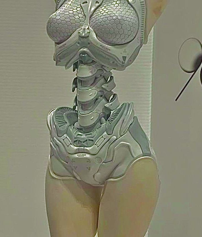 the image shows a stylized, futuristic robotic figure of a humanoid torso with an insectoid aesthetic. the upper part of the body has a headlike structure with large, bulbous eyes featuring a honeycomb pattern. the neck is depicted as a segmented, mechanical column, and the torso is encased in a detailed, gray exoskeleton. the figure has tancolored, seemingly organic legs extending from the robotic hip section. the overall design has a biomechanical quality, blending organic shapes with technological details.