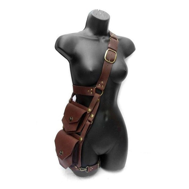 a brown leather thigh holster with a shoulder strap. the holster is made of genuine leather and has a buckle closure. there are multiple pockets on the holster for carrying items. the holster is worn on a mannequin.