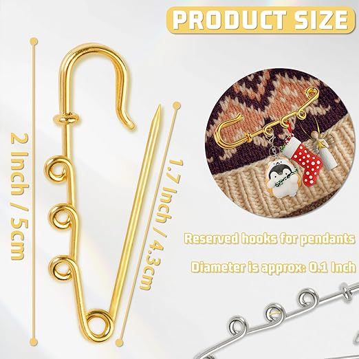 the image shows a product display with a goldcolored decorative safety pin or brooch. the display highlights the product's size with measurements: 2 inches (5cm) for the pin's total length and 1.7 inches (4.3cm) for the pin's needle length. a circular inset showcases the pin in use, attached to a knitted garment and adorned with charms or pendants. the text indicates that the pin has "reserved hooks for pendants" and that the "diameter is approx: 0.1 inch". a similar pin in silver is also partially visible in the lower right corner.