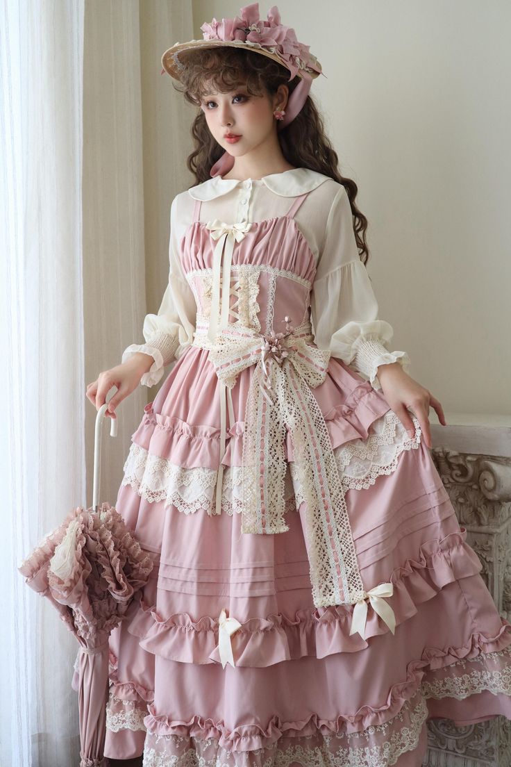 a young woman in a fulllength, pink lolita dress poses in a victorianstyle room. the dress features a white blouse underneath, intricate lace detailing, and delicate ruffles. she's also wearing a straw hat adorned with flowers.  the soft, natural lighting enhances the romantic and feminine aesthetic of the scene.