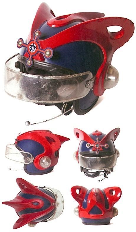the image shows five different angles of a unique and futuristic motorcycle helmet. it is a handmade helmet with a red and blue color scheme. the helmet features a large visor and a variety of other design elements that give it a distinctive and creative look.