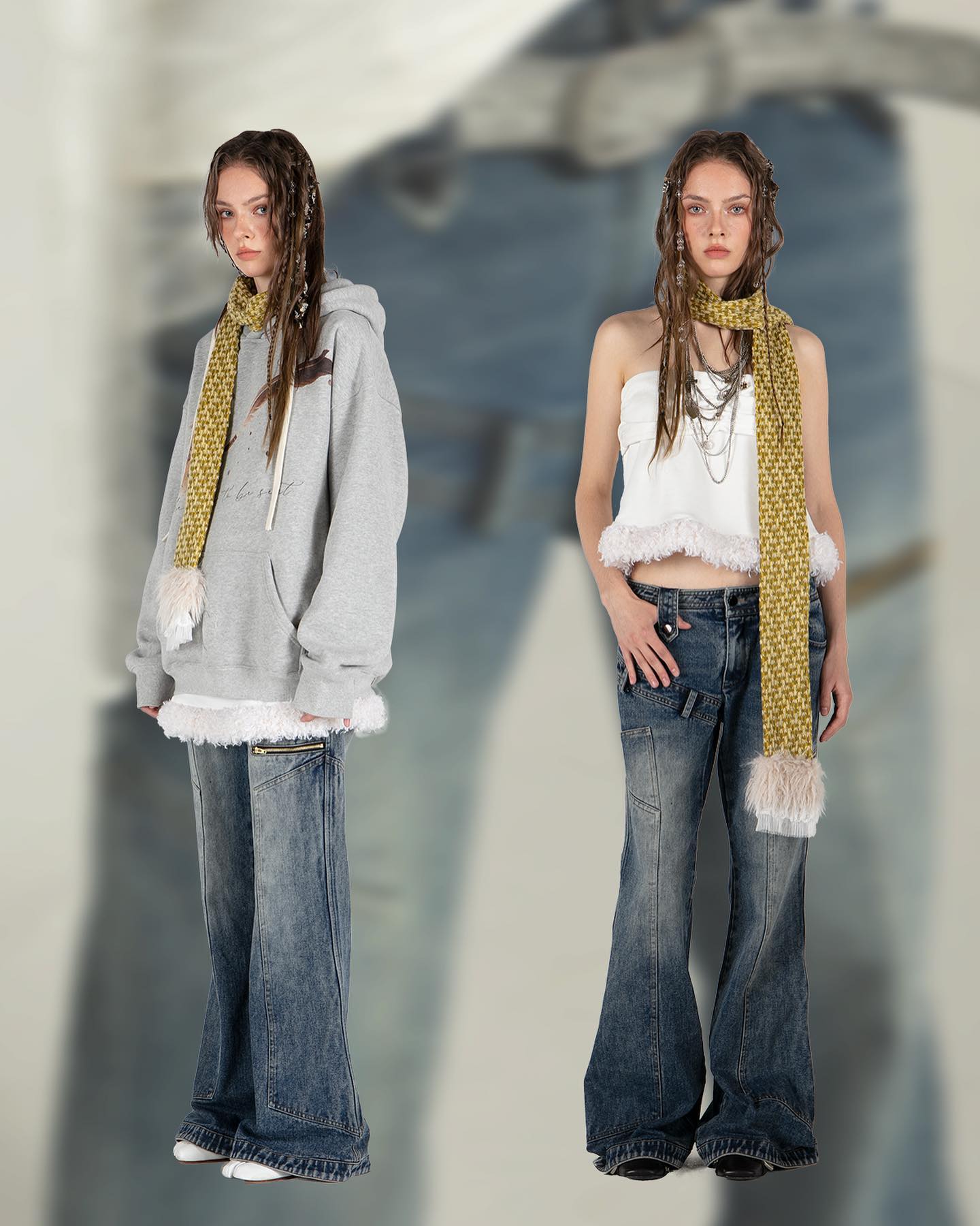 the image showcases two female models, each styled differently, against a blurred background.  both models are wearing bellbottom jeans. one model is wearing a grey oversized hoodie with a white fluffy trim and a yellow and white fringed scarf. the other model wears a white tube top/crop top and a similar yellow and white fringed scarf.  the overall style is casual and trendy, with a focus on the denim and layered clothing items.  the background is intentionally out of focus, drawing attention to the models and their attire.