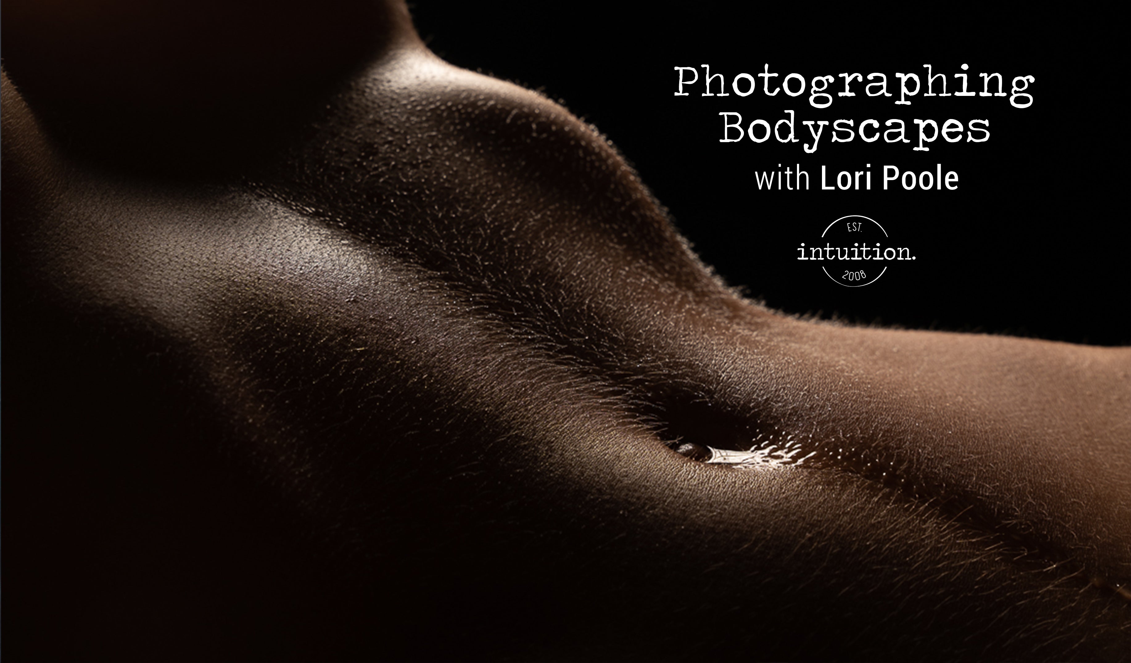 the image is a closeup, lowkey photograph of a woman's torso. the lighting is dramatic, emphasizing the texture and curves of the skin.  the model's belly and lower abdomen are the focal point.  the overall tone is sensual and artistic.  text overlayed on the image advertises a photography workshop titled "photographing bodyscapes with lori poole," presented by "intuition" photography.  the image is designed to attract those interested in art photography and body image.