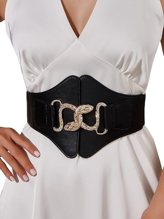 a woman is wearing a white dress with a black wide waist belt that has a gold snake buckle. the belt accentuates her waist and adds a stylish touch to the outfit.