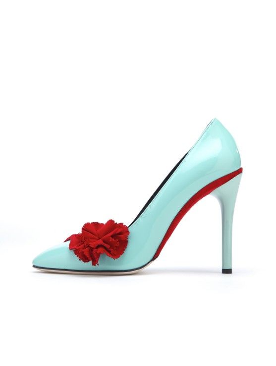 a single light blue high heel shoe with a red flower on the toe is displayed on a white background. the heel of the shoe has a red interior.
