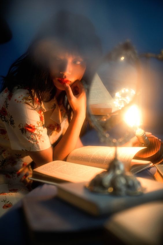 a young woman is engrossed in reading a book under the warm glow of a vintage lamp. she is leaning over the book, her hand resting on her chin in contemplation. the scene evokes a feeling of tranquility and studiousness. the soft lighting and closeup perspective create an intimate atmosphere, emphasizing the woman's focus and the allure of the written word.