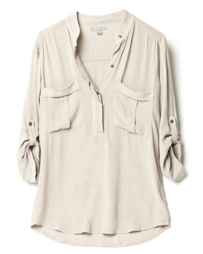 a beige women's shirt with long sleeves and a collared neckline. the shirt is buttondown and has a relaxed fit. it is shown on a white background.