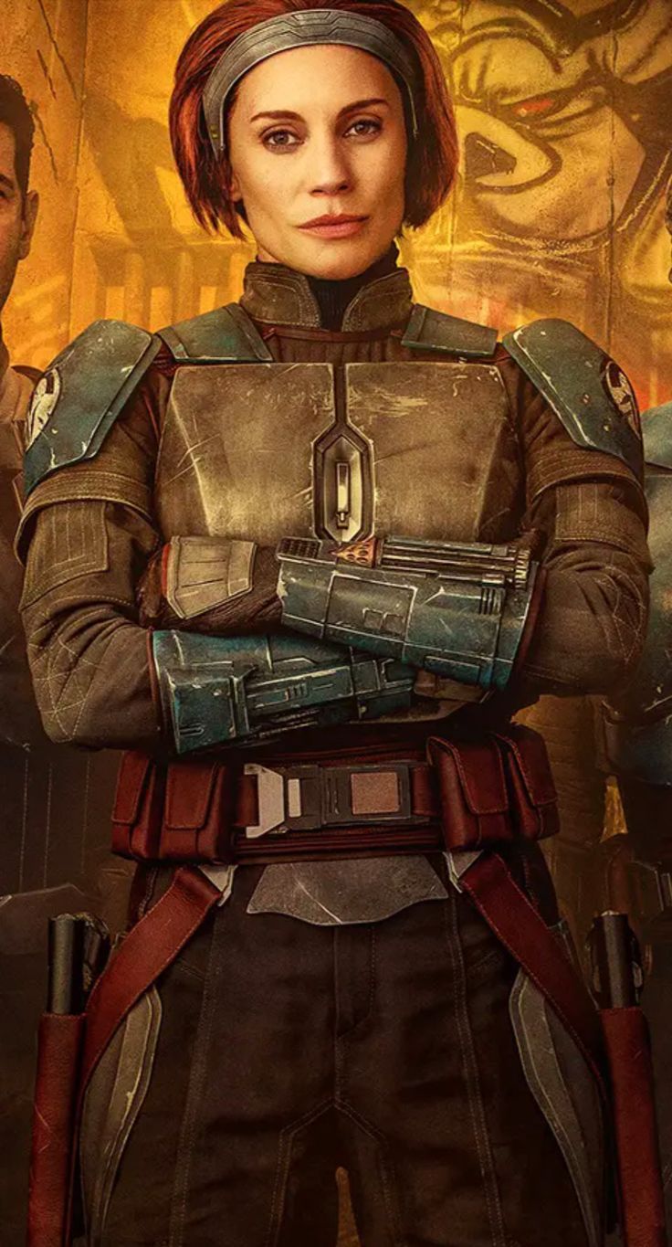 a portrait of actress katee sackhoff as bokatan kryze from star wars, wearing mandalorian armor and holding a blaster pistol. she has a headband and is standing with her arms crossed.