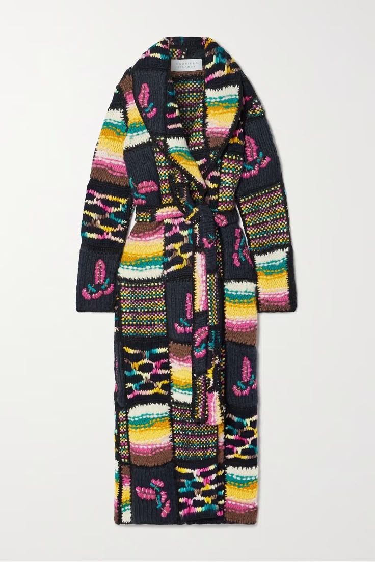 a multicolored, floral patterned knitwear robe is centered in the image. it features a dark background adorned with patches of various colors, including yellow, pink, brown, and white, arranged in horizontal stripes or blocks. the design incorporates floral motifs scattered across the surface. it also has a belted waist.