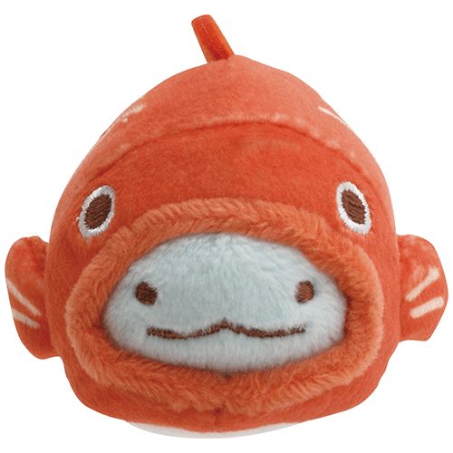 the image shows a closeup of an orange plush toy shaped like a fish. the toy has a round body, small fins, and a rounded face with small eyes, a pale blue snout, and stitched whiskers forming a smile. it appears soft and cuddly, suitable as a children's toy.