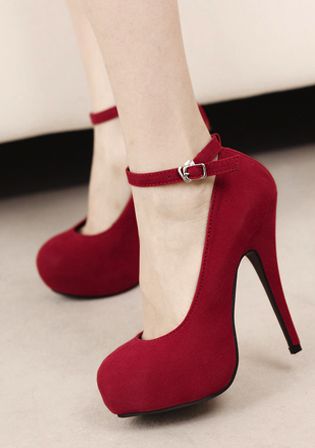 a woman's feet wearing a pair of beautiful red highheeled shoes. the shoes are made of suede and have a stiletto heel. the woman is wearing the shoes with a formal dress. she looks elegant and classy.