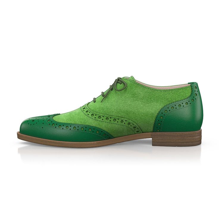 the image showcases a single, stylish women's green shoe set against a clean white background.  the shoe is a brogue or wingtip oxford style, featuring a combination of green suede and leather. the shoe has a low heel and laces. the lighting and background are carefully controlled to highlight the shoe's details and color. the image is likely used for product photography or fashion purposes.