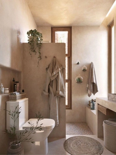 the image showcases a minimalist bathroom designed with natural materials and earthy tones.  the walls are a light beige, complementing the neutraltoned wooden window frame and the beige floor tiles.  a simple, white toilet and a beige bathrobe hanging on the wall are the main features.  small potted succulents and a hanging plant bring in elements of nature. a woven rug adds a touch of warmth, and wicker storage adds to the organic aesthetic. the overall feel is serene, calm, and ecofriendly.  the lighting is soft and natural, creating a relaxing spalike ambiance.