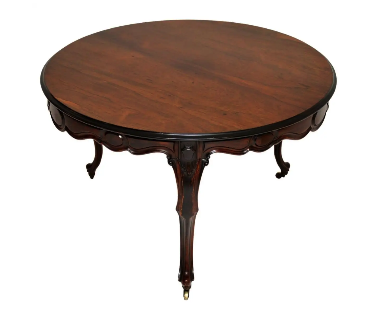a round antique mahogany table with ornate carved legs and a black border around the top. the table is isolated on a white background.