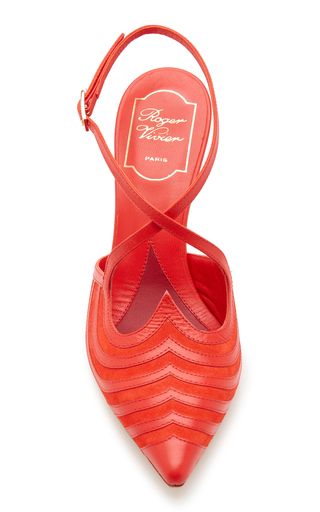 a pair of bright red roger vivier women's shoes. the heels are pointytoed and have a crisscross strap at the ankle. the heels are high and slender. the shoes are made of leather and have a luxurious, designer look.