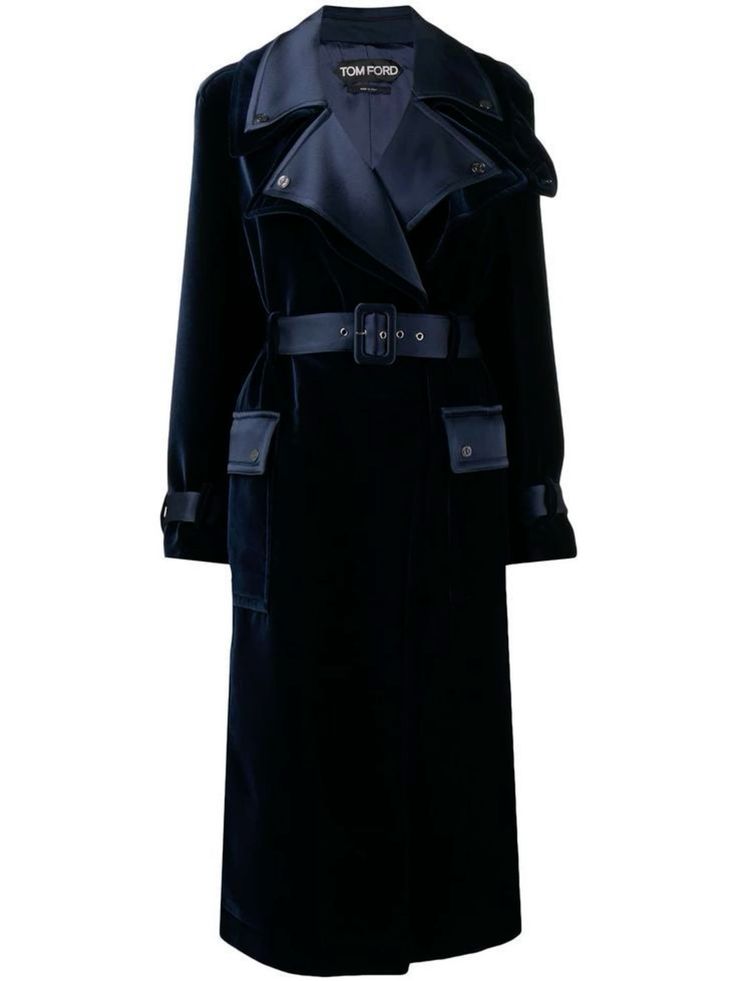 a navy blue velvet trench coat for women by tom ford. the coat is long, with a collar, a belt, and pockets. it is a great option for fall and winter.