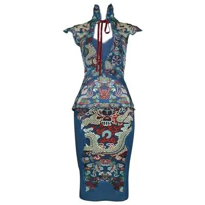the image shows a blue sheath dress with a high neck, sleeveless design, and a floral pattern throughout.