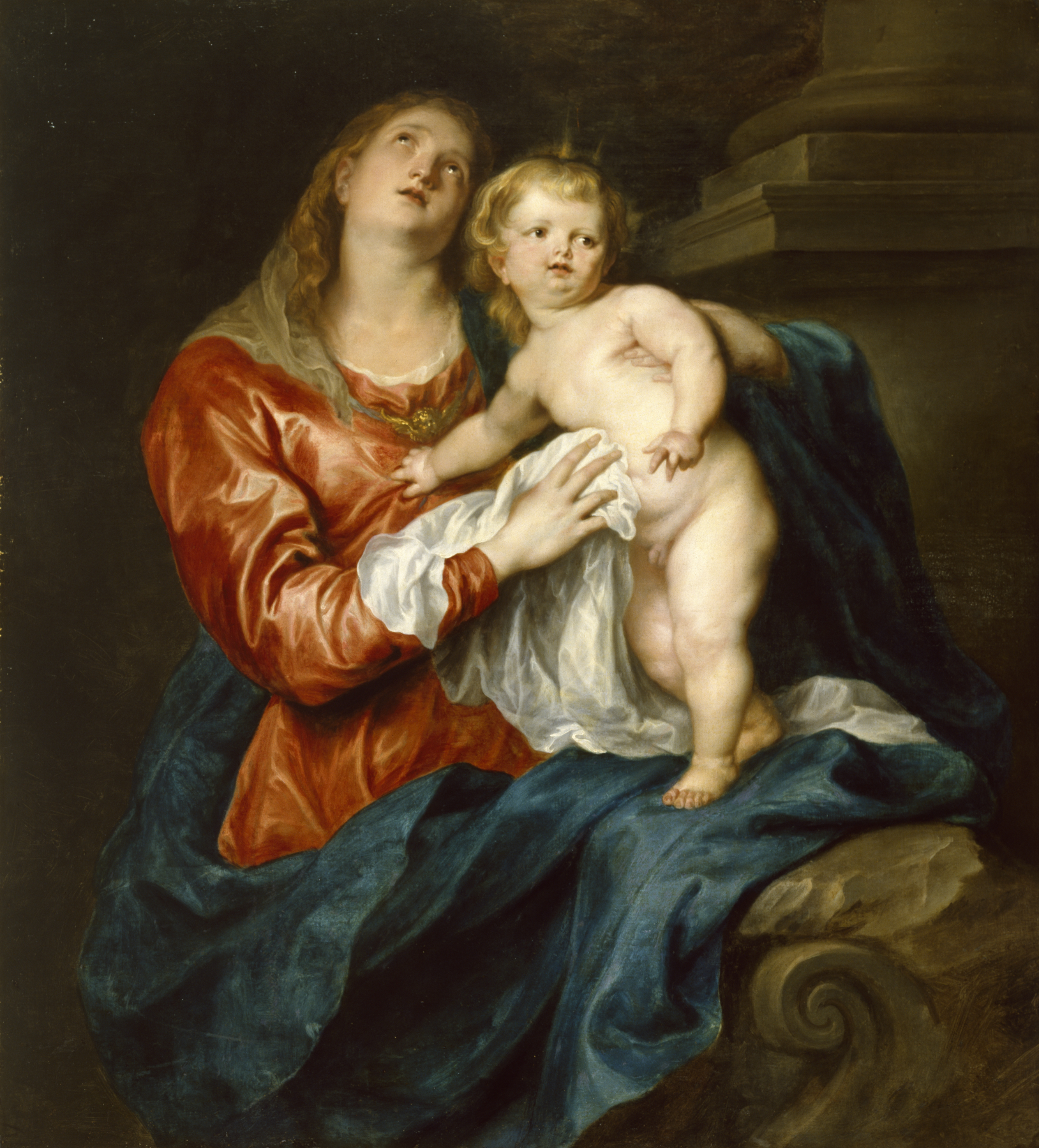 this painting depicts the virgin mary holding baby jesus, the two seated on a stone platform. the painting is a classic example of the baroque style, which emphasizes drama, emotion, and movement. the virgin mary is clothed in rich colors, with a red and blue dress, and her face is gentle and loving. baby jesus is naked, and his expression is innocent and serene. the painting is set against a dark background, which emphasizes the figures and their heavenly glow. this painting is a powerful representation of the virgin mary and baby jesus, as well as the love and protection that they offer to believers.