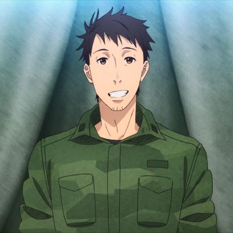 a young man with short dark brown hair and a friendly smile is wearing a green camo military uniform. he is standing in front of a light blue wall. the background is blurred. he is looking directly at the camera. he is smiling happily.