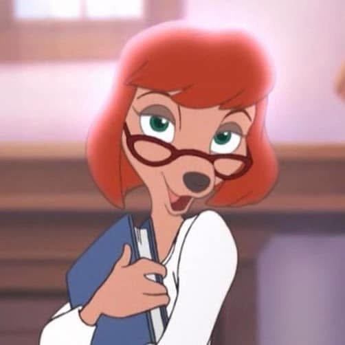 the image shows a closeup of an animated female fox character, possibly from a disney film,  who resembles a teacher or librarian.  she has bright red hair, wears glasses, and is holding a blue book.  she's smiling and appears friendly.  her character design is reminiscent of classic disney animation style. the background suggests an office or school setting.  the character's overall appearance is inviting and approachable.