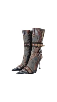 a pair of brown leather boots with stiletto heels. the boots are adorned with buckles and other embellishments. the boots are a fashionable and elegant footwear option for women.