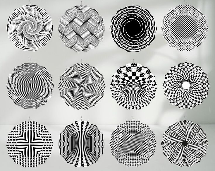 the image features a collection of twelve circular, black and white geometric patterns hanging from what appears to be a wall. the patterns are diverse, ranging from spirals and wavy lines to checkered designs and radial arrangements, creating various optical illusions. the monochrome color scheme and abstract nature of the designs contribute to a modern and artistic aesthetic. the items appear to be decorative pieces, possibly part of an art installation or intended as wall decor.