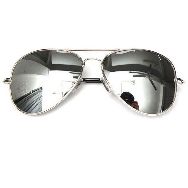 a pair of silver aviator sunglasses with reflective lenses are centered in the frame on a white background. the reflection on the lenses show a person taking the photograph and room interior in the other lens.